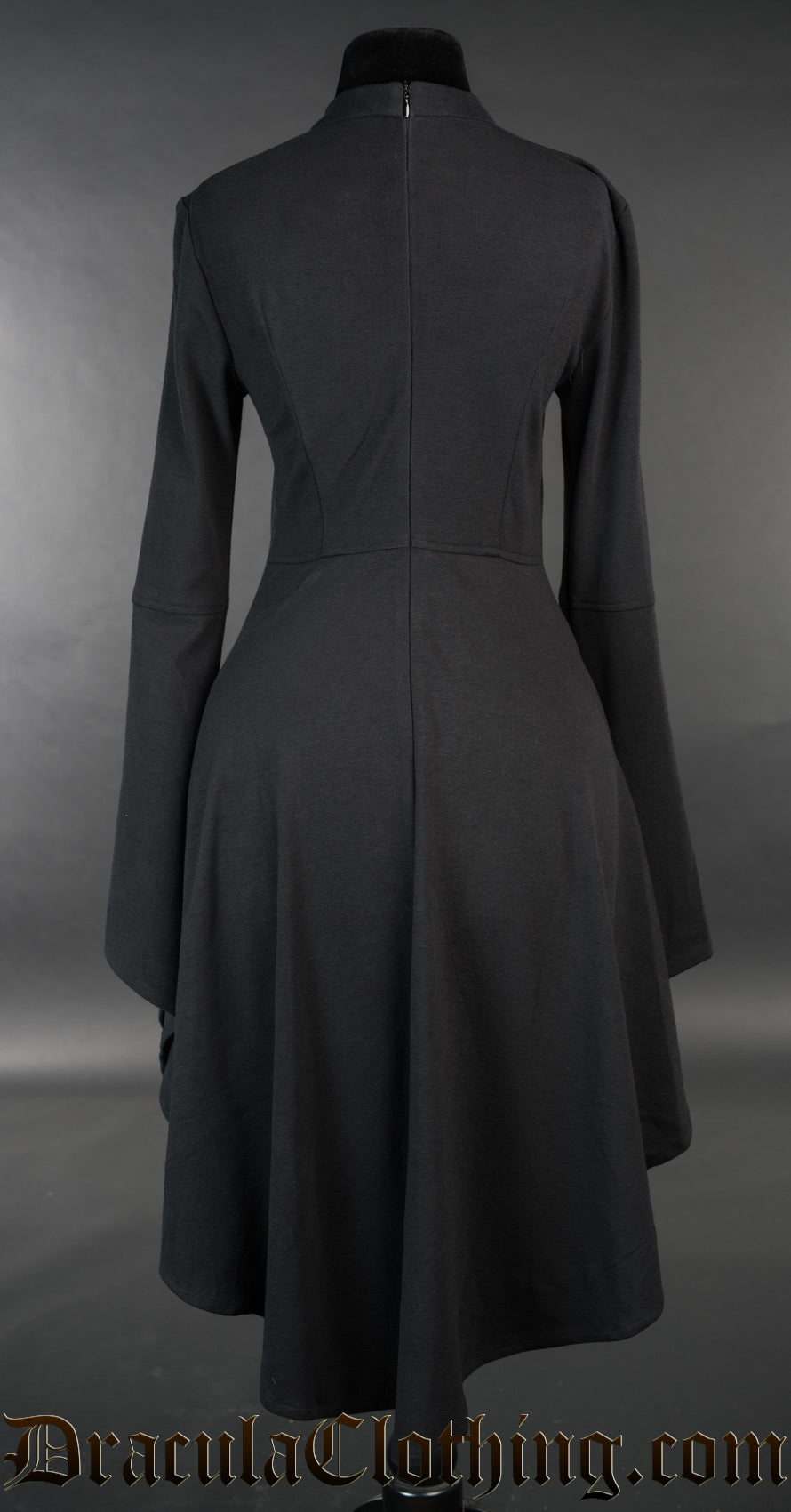Back view of black cotton women's dress longer in the back than the front and flared trumpet sleeves