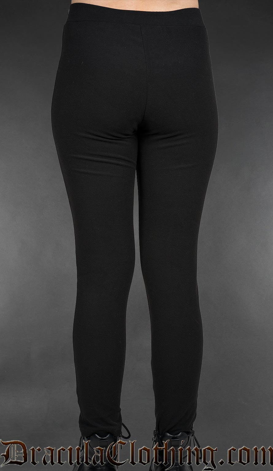 Black gothic high-waisted leggings with embroidered ankh symbols and fitted stretch silhouette worn by a model back view