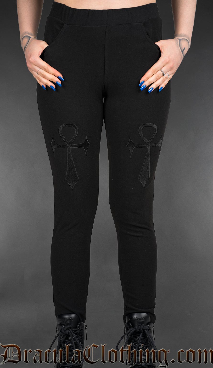 Black gothic high-waisted leggings with embroidered ankh symbols and fitted stretch silhouette worn by a model