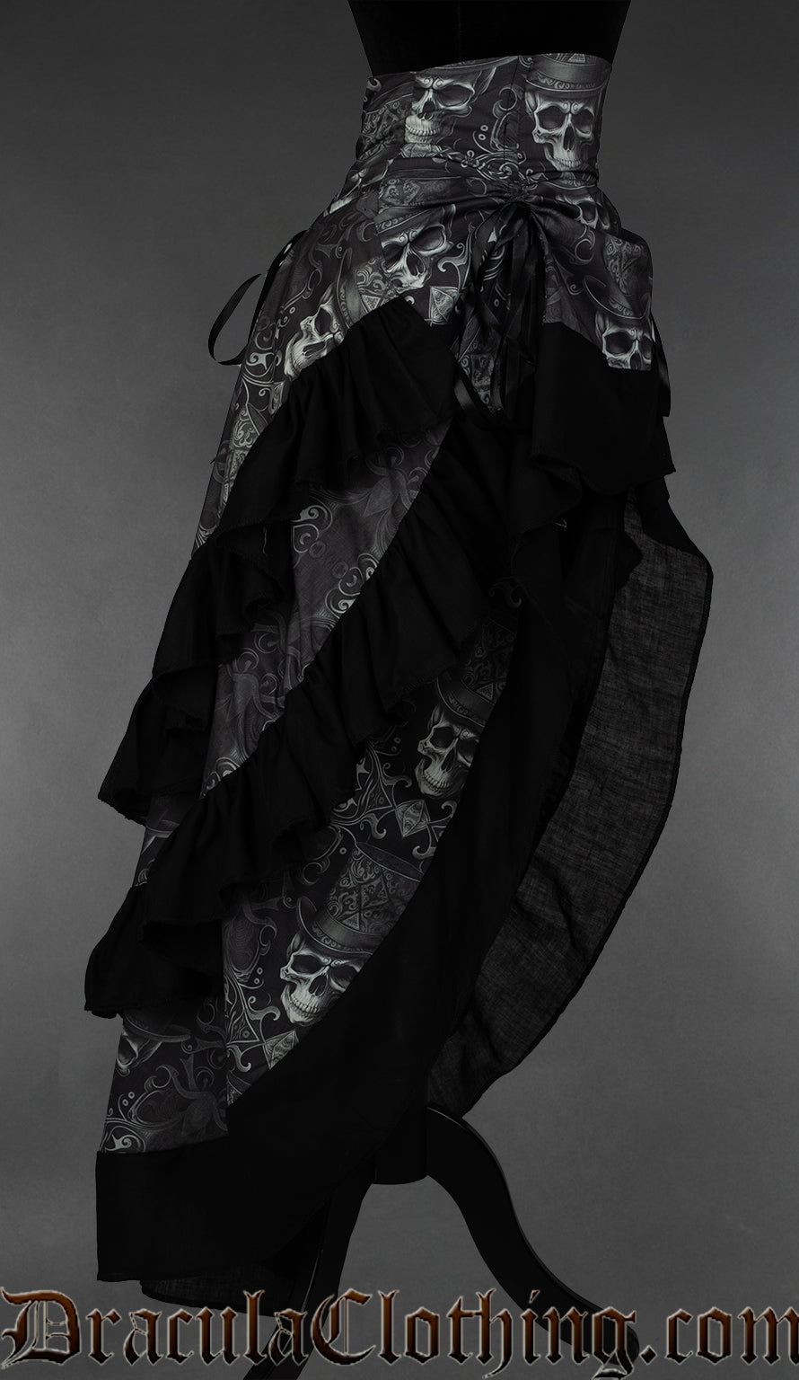 Side view of grey skull printed bustle skirt showing three layers of fabric with black cotton hem on each one