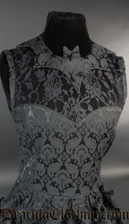 Close up of bat collar and sheer lace illusion chest panel on black brocade women's dress