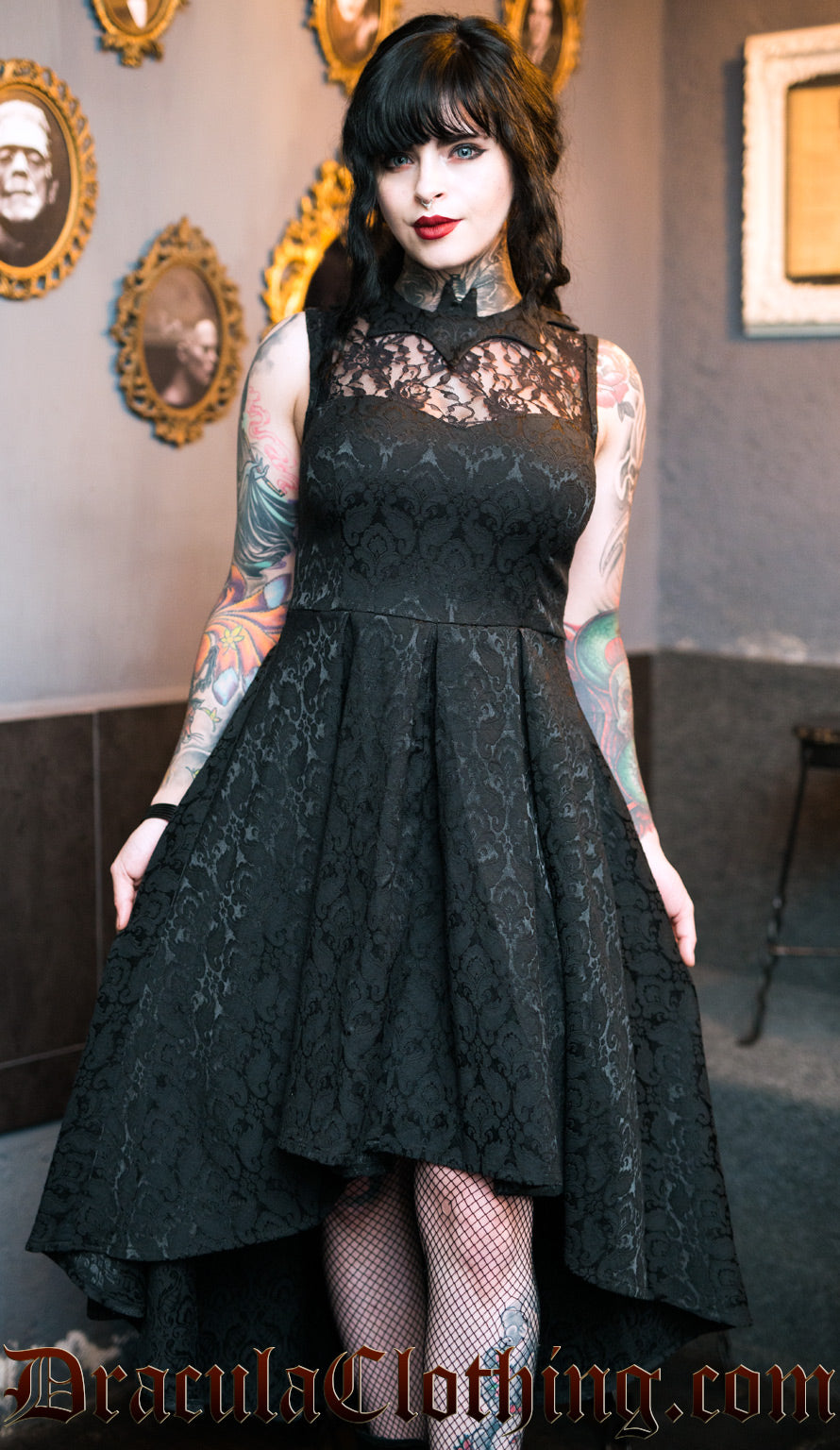 Women's black brocade dress with bat shaped collar, lace chest illusion and high low style skirt
