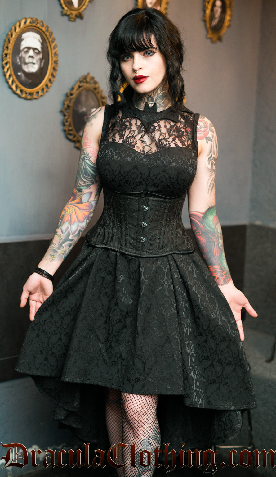 Sleeveless women's high low dress with lace chest panel and bat shaped collar made from black cotton brocade fabric