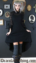 Model wearing black high low dress with lace top layer and sheer lace sleeves