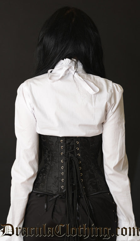 Back view of model wearing black brocade underbust corset showing matching modesty panel and adjustable lacing