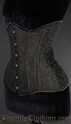 Side view of black brocade corset showing extreme waist style shaping