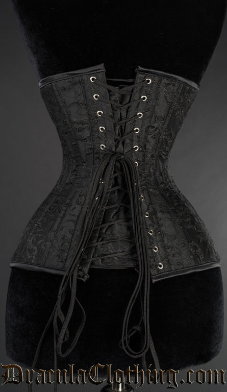 Back view of black broacade extreme waist corset showing adjustable lacing and matching fabric modesty panel