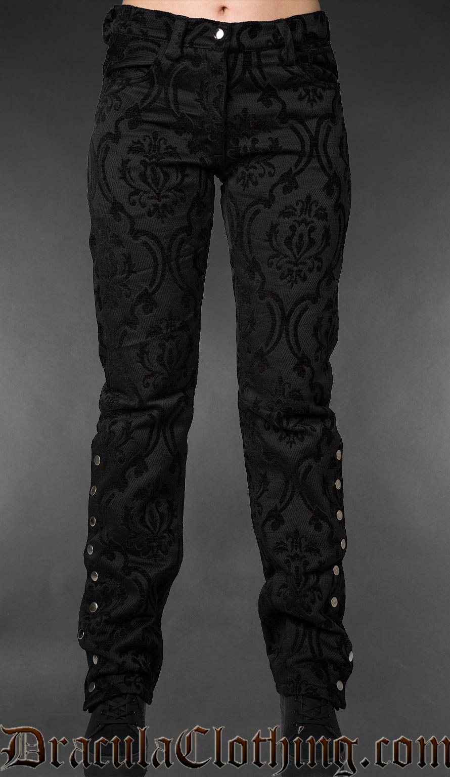 Front view of black gothic brocade officer pants with metal buttons along the lower outer legs on a gray background