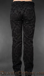 Back view of black gothic brocade officer pants with intricate pattern on a gray background