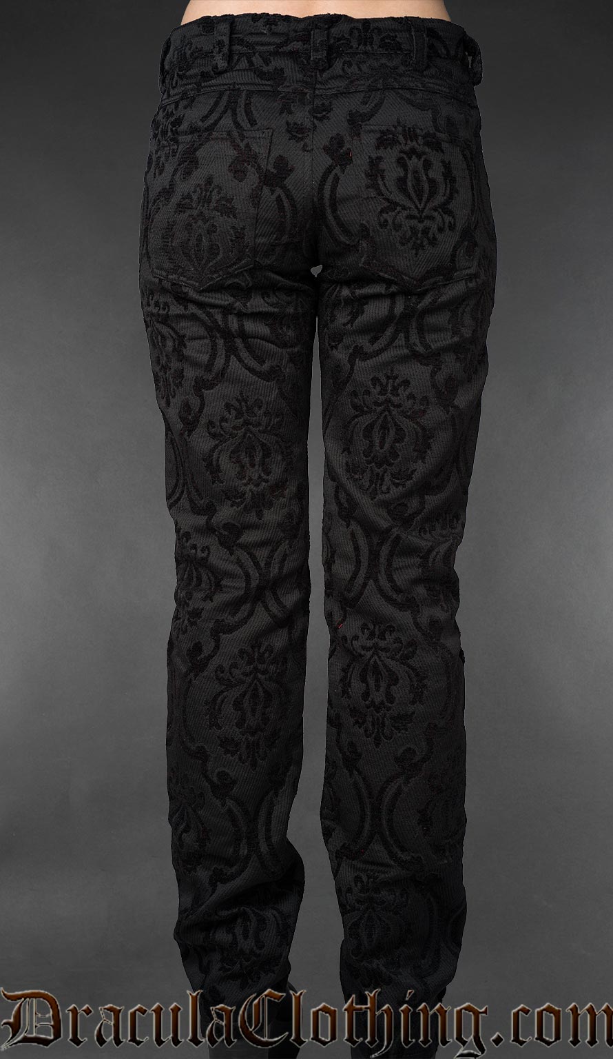 Back view of black gothic brocade officer pants with intricate pattern on a gray background