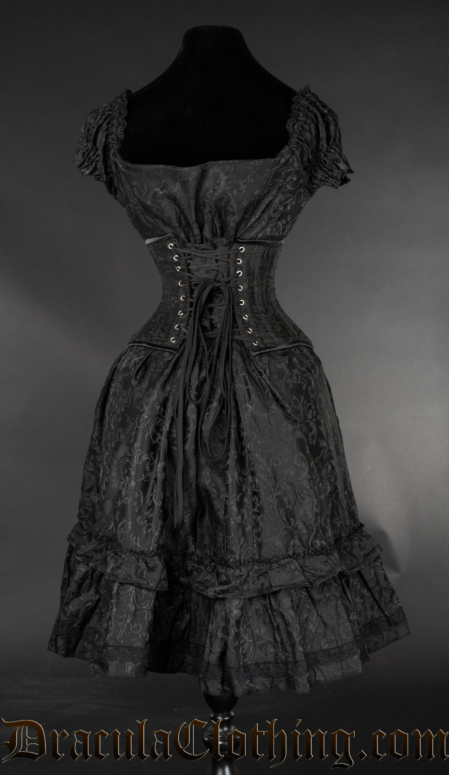 Back view of women's black brocade dress shown with waist cincher