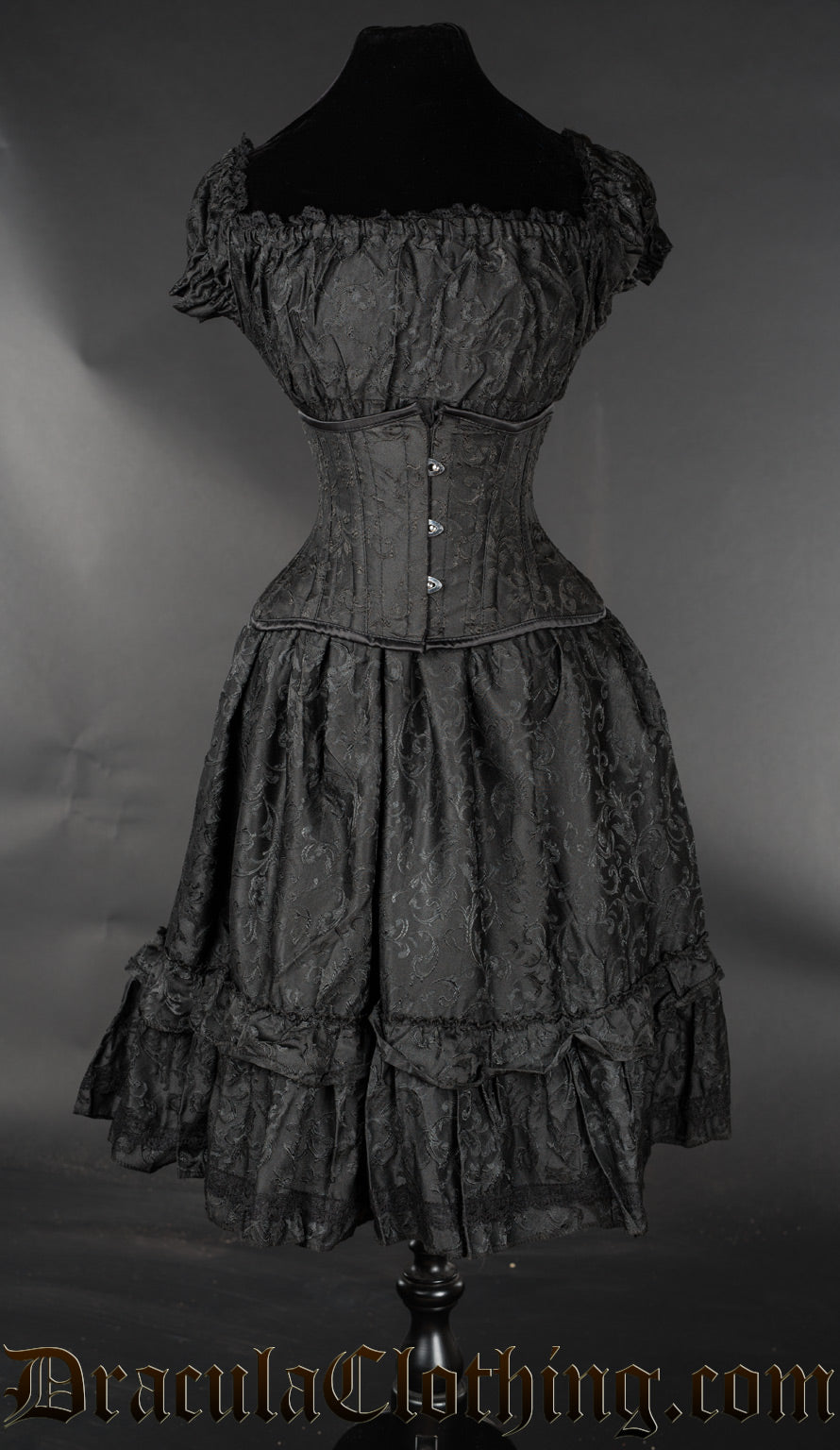 Black brocade women's knee length square neckline dress with stretchy bust and sleeves shown with waist cincher