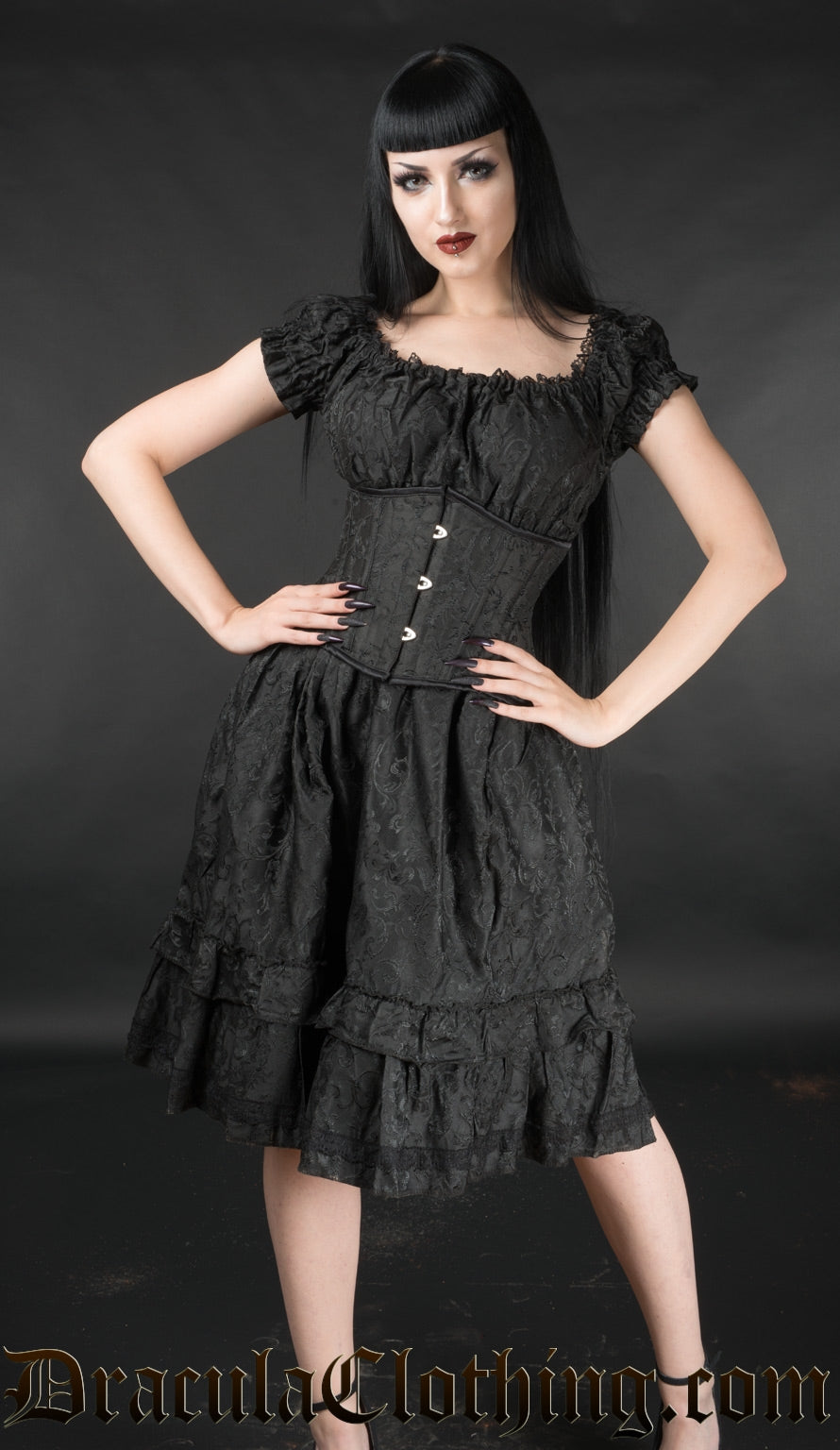 Model wearing women's black brocade dress with matching waist incher