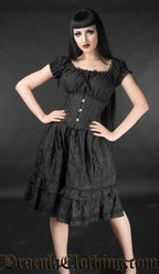Model wearing women's black brocade dress with matching waist incher