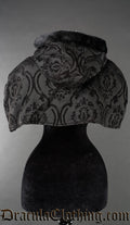 Back view of women's attachable hood and cape made with black brocade thick jacquard fabric and black faux fur
