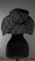 Back view of women's attachable hood and cape made with black brocade thick jacquard fabric and black faux fur