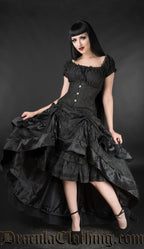 Model wearing women's black brocade layer bustle skirt over matching gothabilly dress and with additional waist cincher