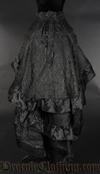 Back view of women's black brocade bustle skirt showing three layers of fabric with black satin hem accents and adjustable lacing in the waist