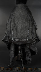 Black brocade bustle skirt shown lowered in the front