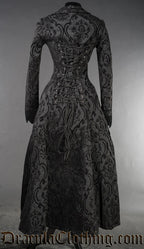 Back view of women's black brocade long coat showing adjustable corset style lacing that goes up the back
