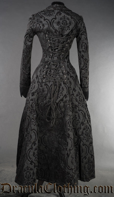 Back view of women's black brocade long coat showing adjustable corset style lacing that goes up the back