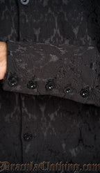 Detailed view of metal buttons with DraculaClothing etching