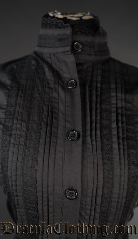 Close up of collar on women's black edwardian blouse showing black lace trim on high neck collar and pleated design with lace details