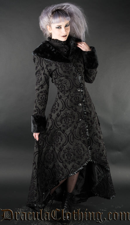 Women's black brocade high low coat with faux fur trim worn by a model