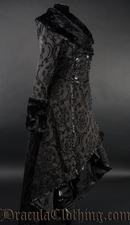 Side view of women's black brocade winter coat showing high low hem that is longer in the back than the front
