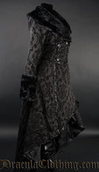 Side view of women's black brocade winter coat showing high low hem that is longer in the back than the front