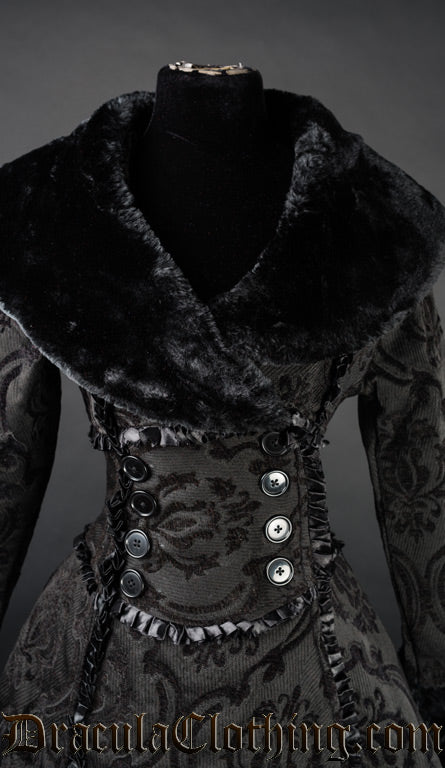 Close up front view of women's black winter coat showing wrap neckline and faux fur collar
