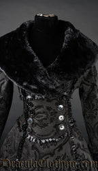 Close up front view of women's black winter coat showing wrap neckline and faux fur collar