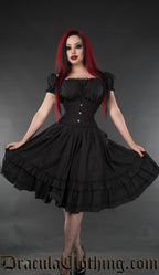 Black short sleeved knee length women's dress with black lace details worn with waist cincher
