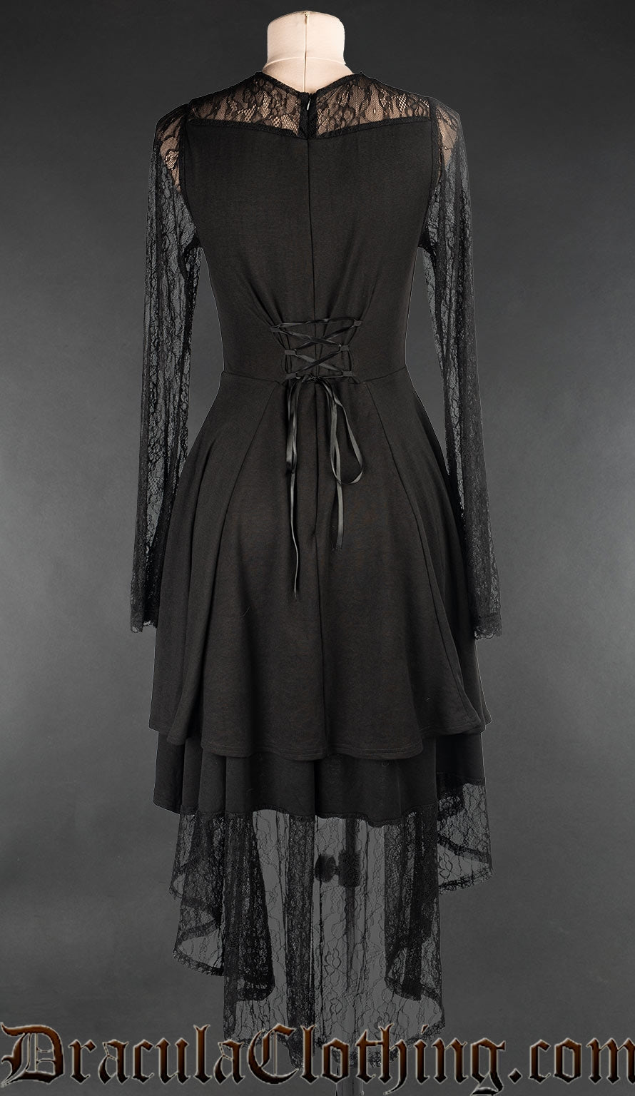 Back view of women's knee length black dress showing back lace skirt layer that is longer in back and adjustable lacing in torso