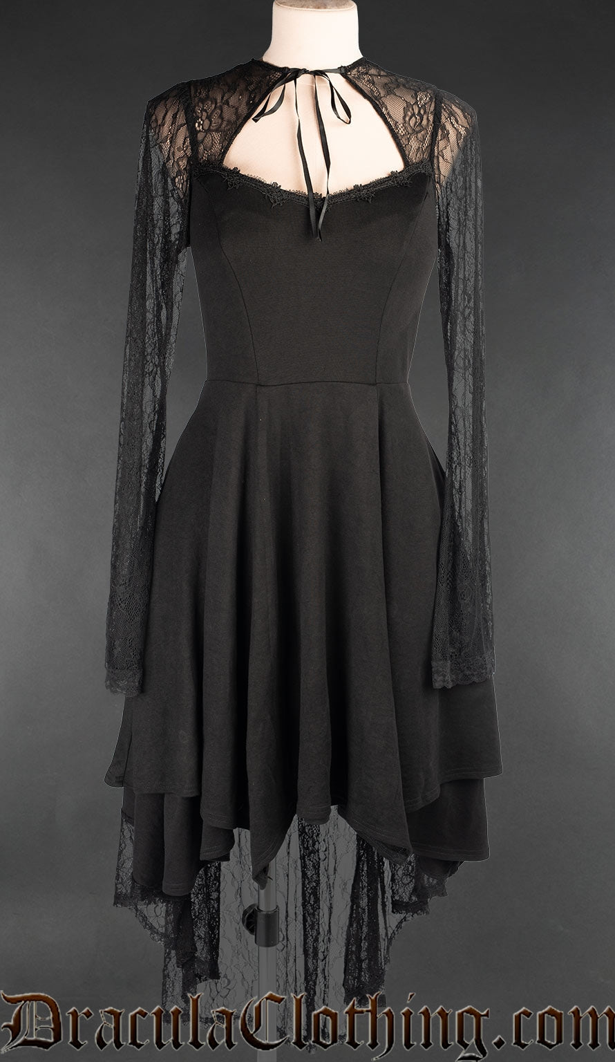 Women's black knee length dress with longer lace back in the skirt and lace trumpet sleeves open chest panel
