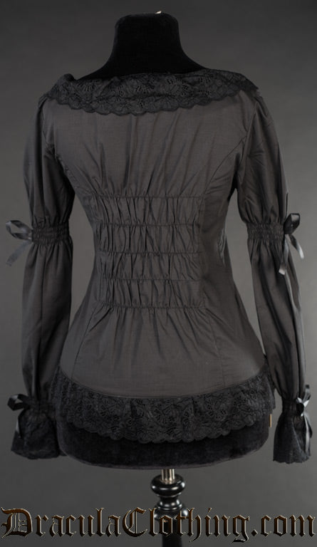 Back view of women's black blouse showing elasticated back and elastic in the sleeves for a dynamic fit
