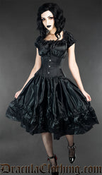 Women's knee length sleeveless black satin dress with lace details worn by a model with additional matching waist cincher