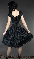 Model showing back view of black satin women's dress worn with waist cincher