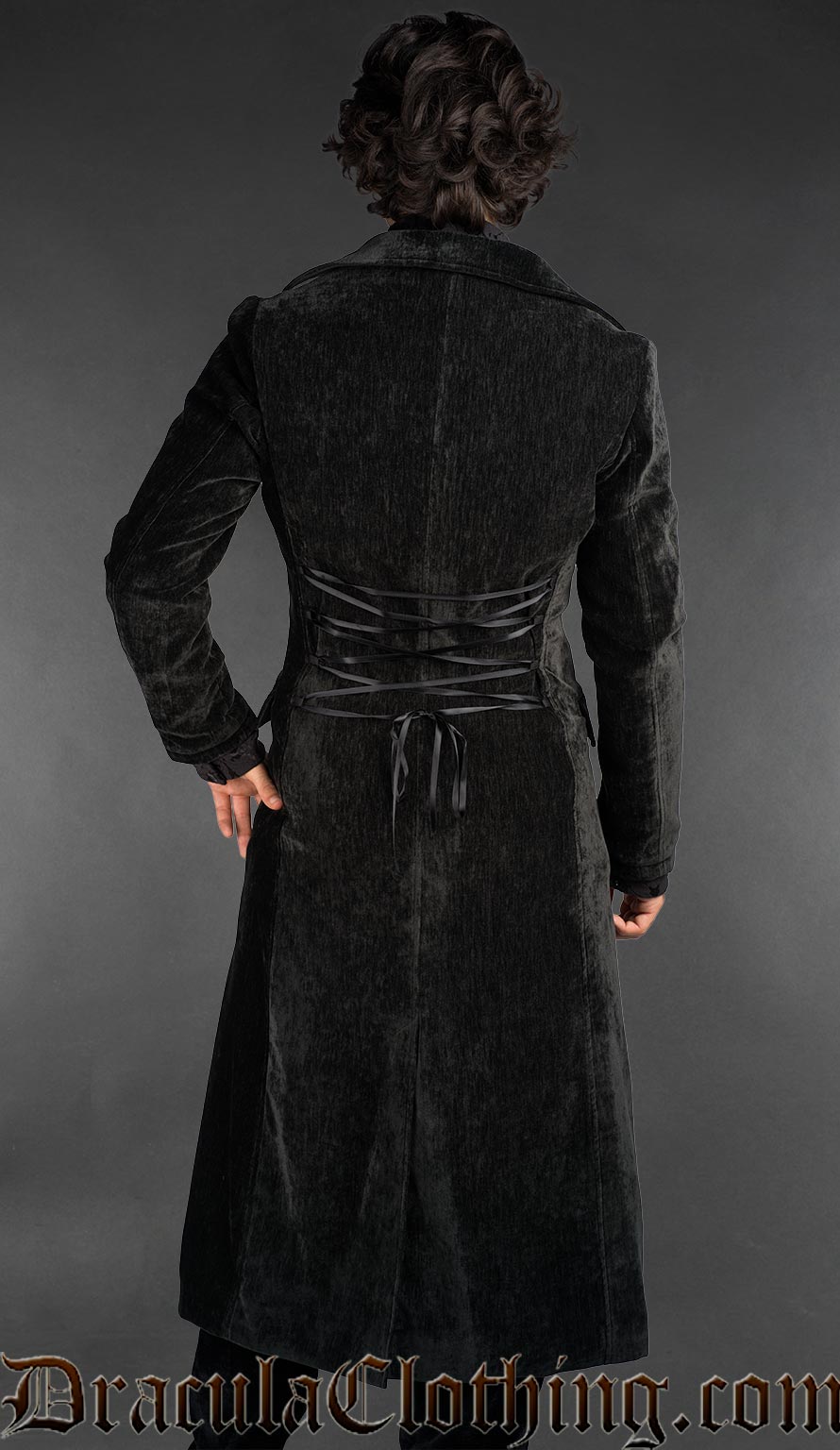Back view of Victorian gothic black velour long coat for men, tailored silhouette with button front, styled over a black shirt