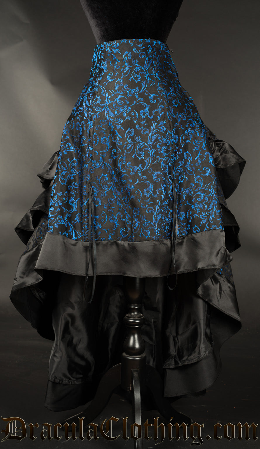 Front view of blue brocade bustle skirt shown with the front lowered