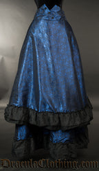 Front view of women's blue bustle skirt with front layer of fabric shown lowered to it's full length
