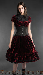 Model wearing women's red knee-length velvet dress with waist cincher and collar