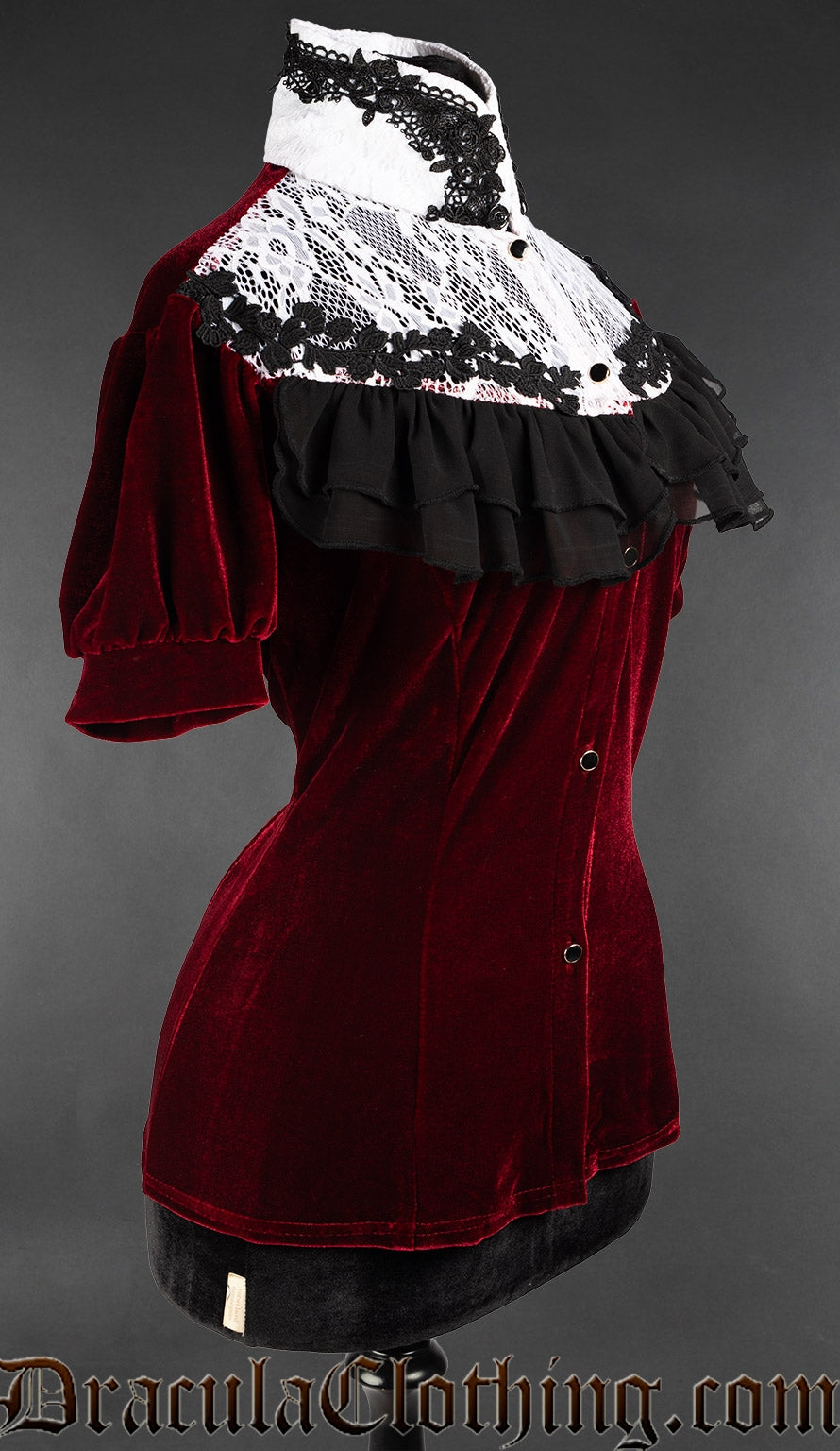 Side detailed view of bordeaux short sleeved velvet blouse showing black ruffles and white lacing