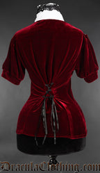 Back of red velvet short sleeved blouse showing adjustable corset style lacing in the back