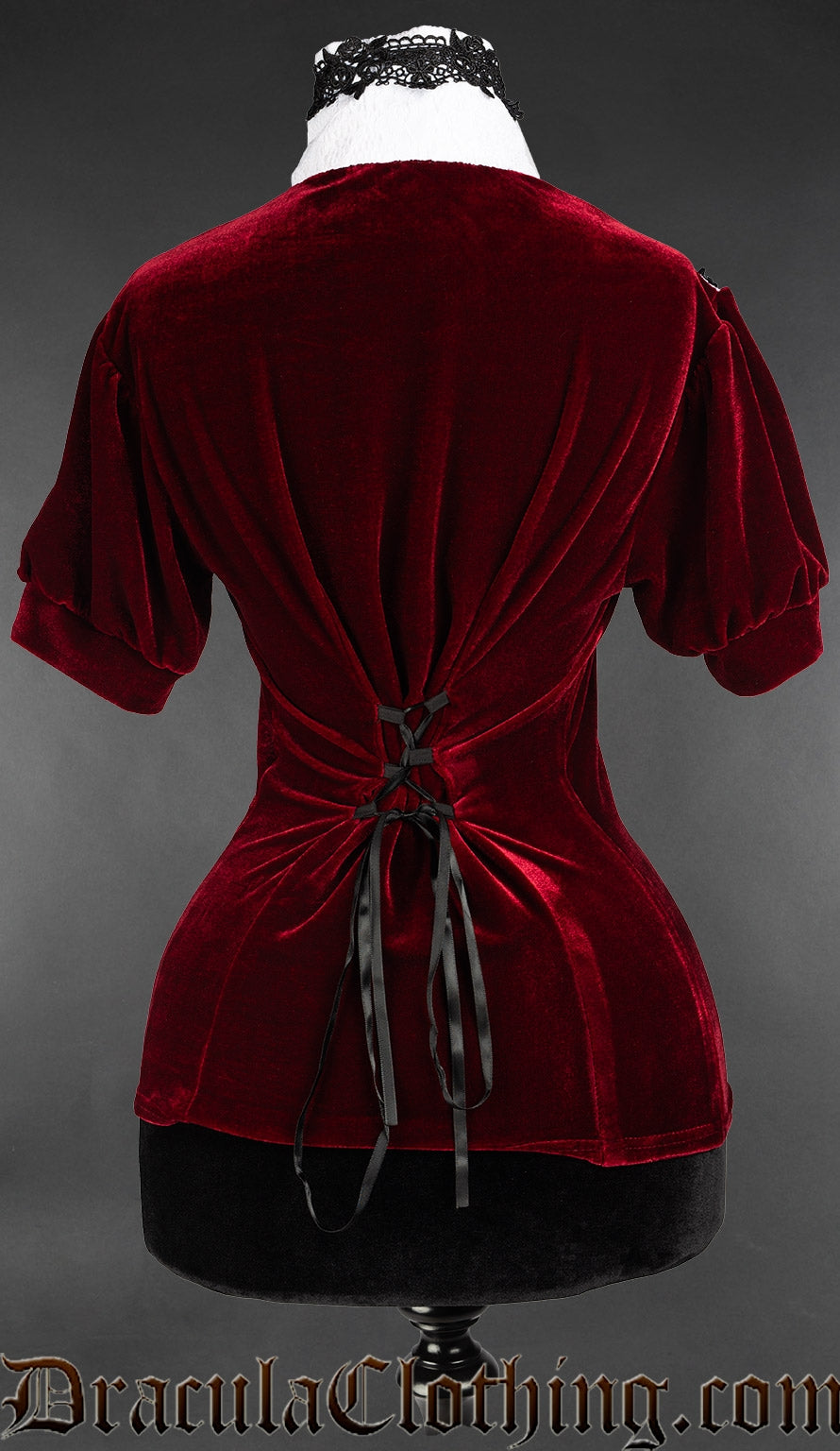 Back of red velvet short sleeved blouse showing adjustable corset style lacing in the back