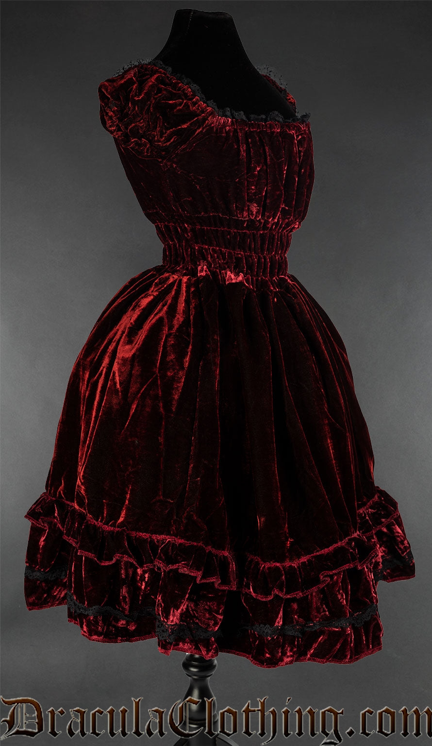 Side view of red bordeaux velvet women's dress with black lace trim and elasticated bust waist and sleeves