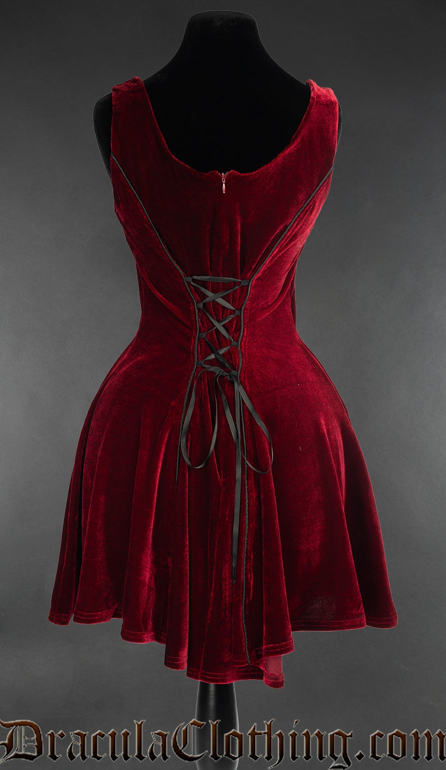 Back view of women's short sleeveless red velvet dress showing adjustable lacing in torso