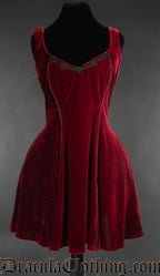 Women's red velvet short sleeveless dress with black piping and embroidered details