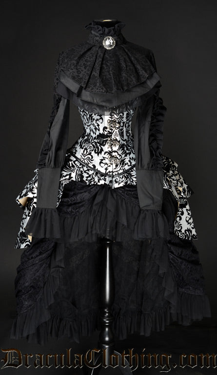 Women's black high waisted bustle skirt showed layered with an additional bustle corset and blouse