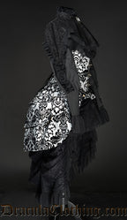 Side view of women's high waisted black bustle skirt worn under a bustle corset and black blouse